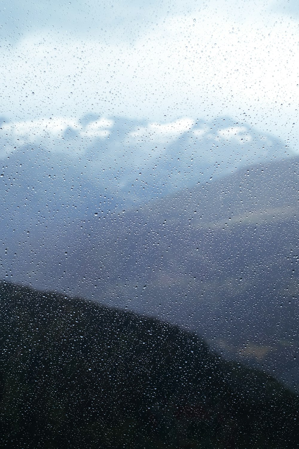 silhouette of mountain under white clouds during daytime