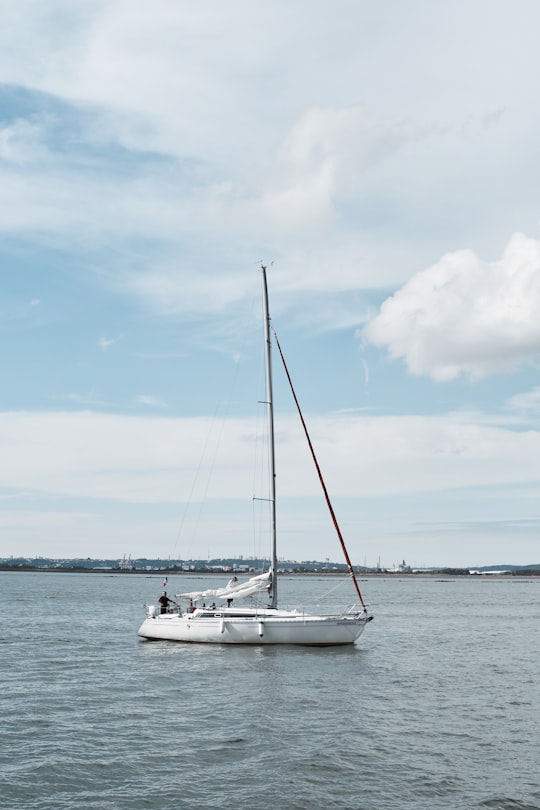 white sail boat on sea under blue sky and white clouds during daytime in Honfleur France