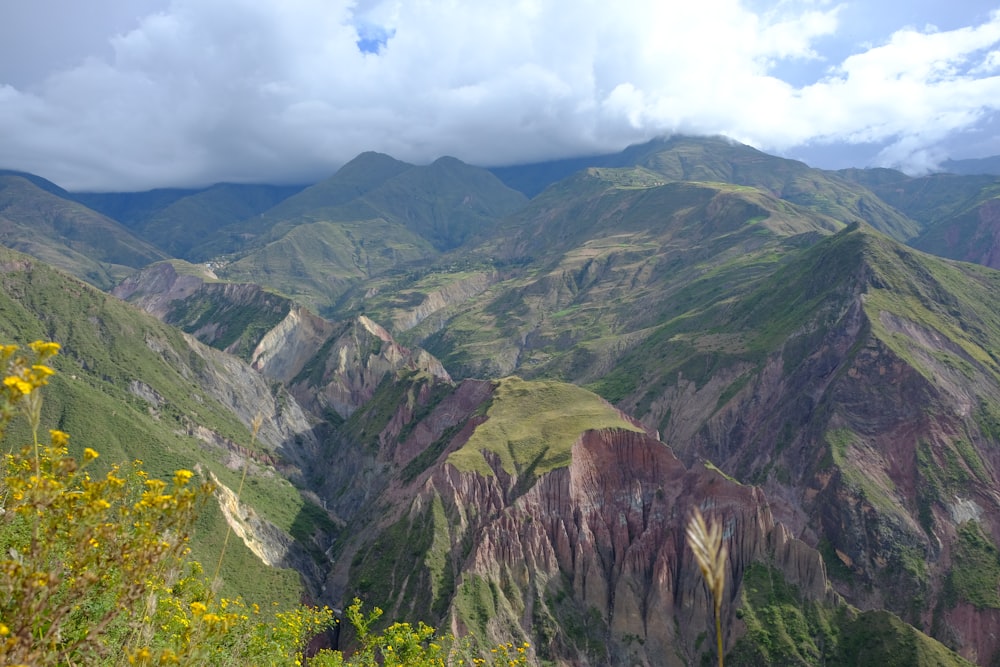 green and brown mountains under white clouds during daytime