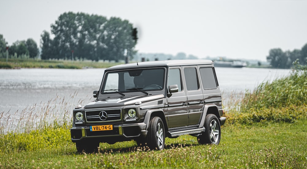 black suv on green grass field during daytime