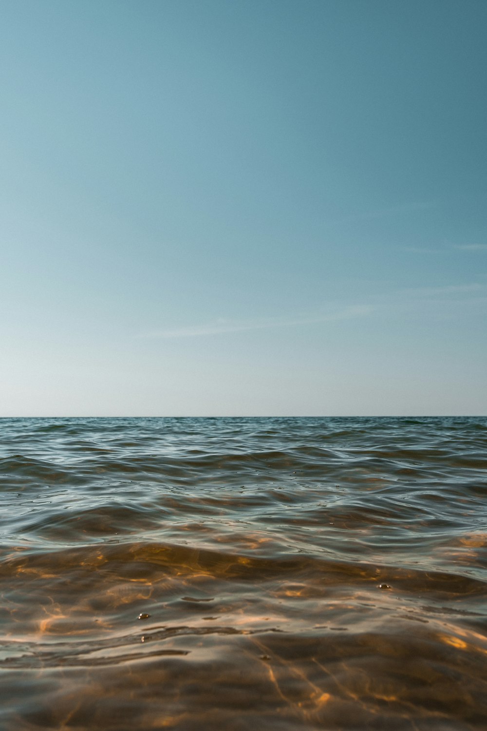 body of water under blue sky during daytime