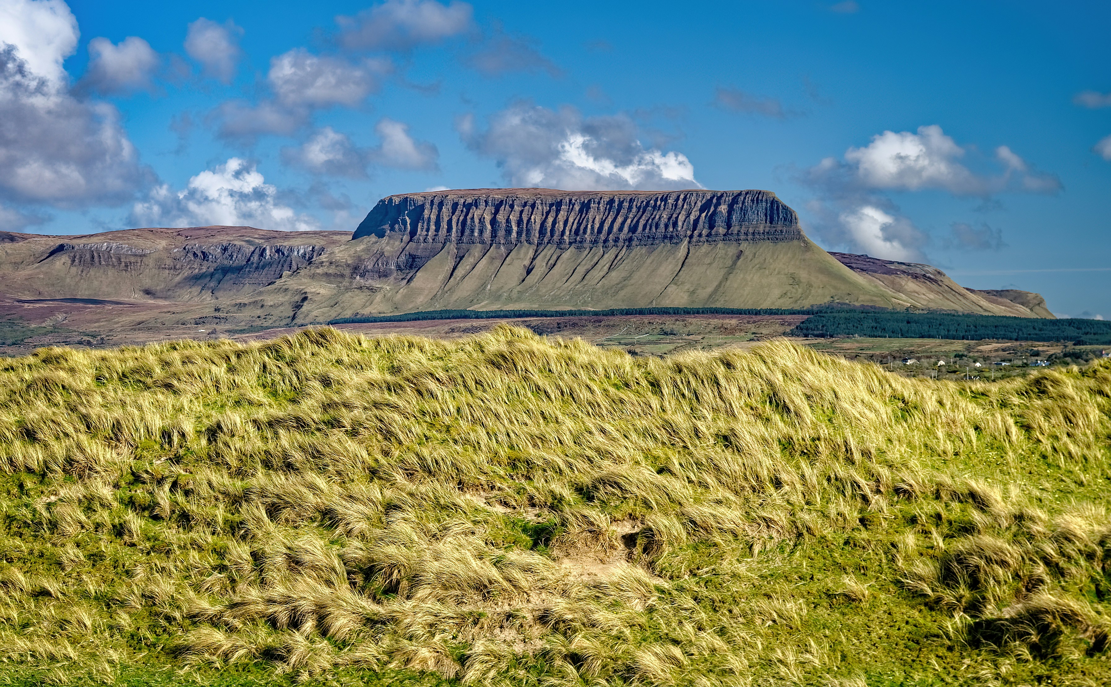 green grass field near mountain under blue sky during daytime, Ben Bulben rock formation, which is said to have been a hunting ground of the legendary Fianna warriors in the 3d century AD in Ireland