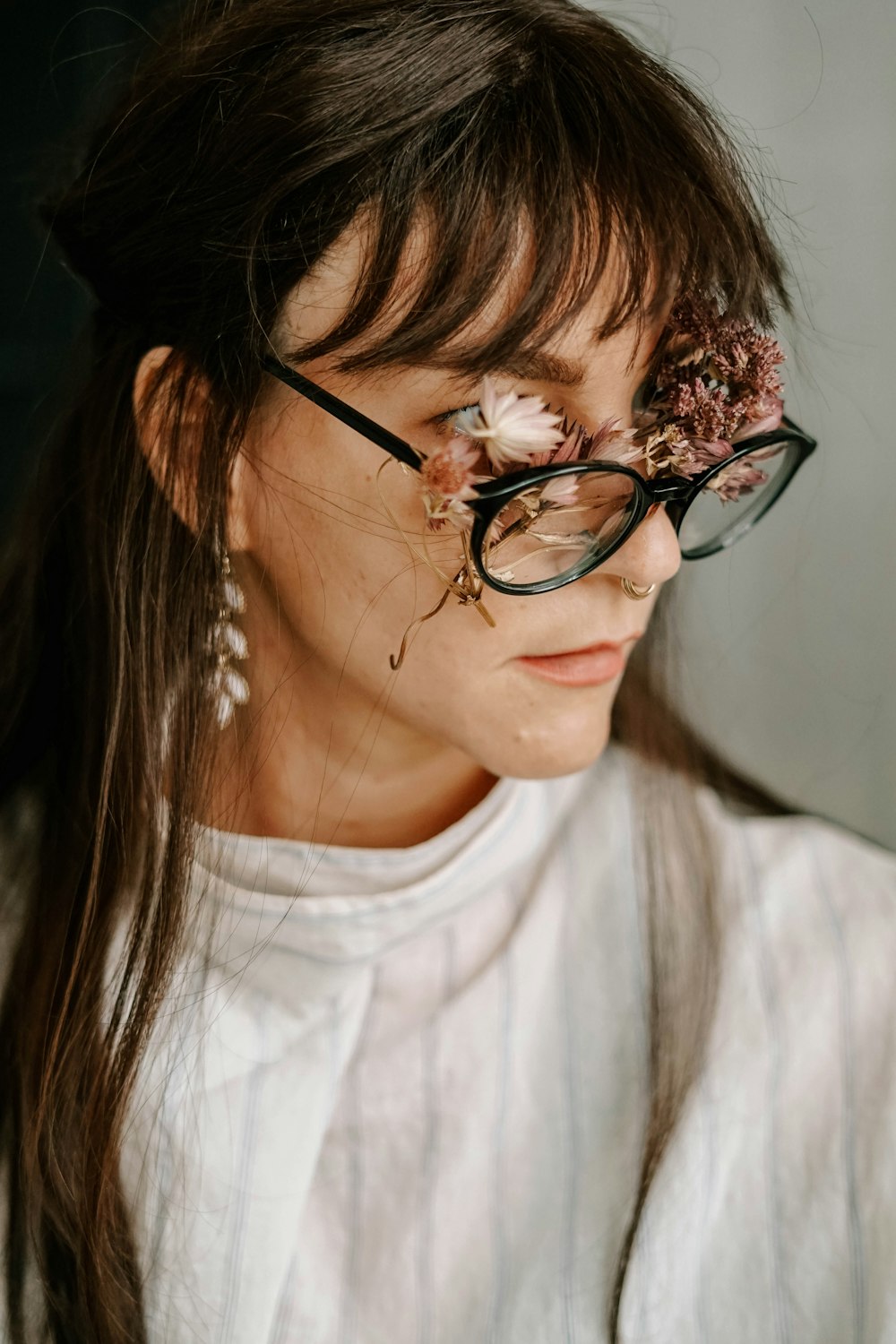 woman in white crew neck shirt wearing black framed eyeglasses