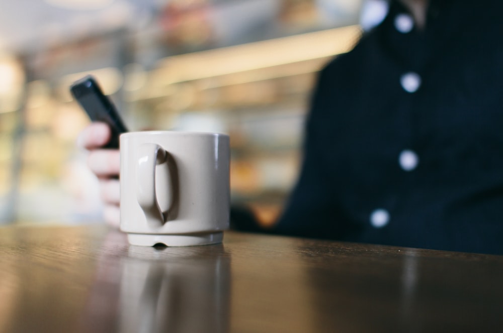 white ceramic mug on table