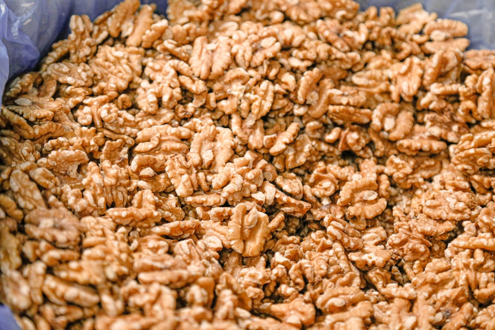 brown peanuts on blue ceramic bowl