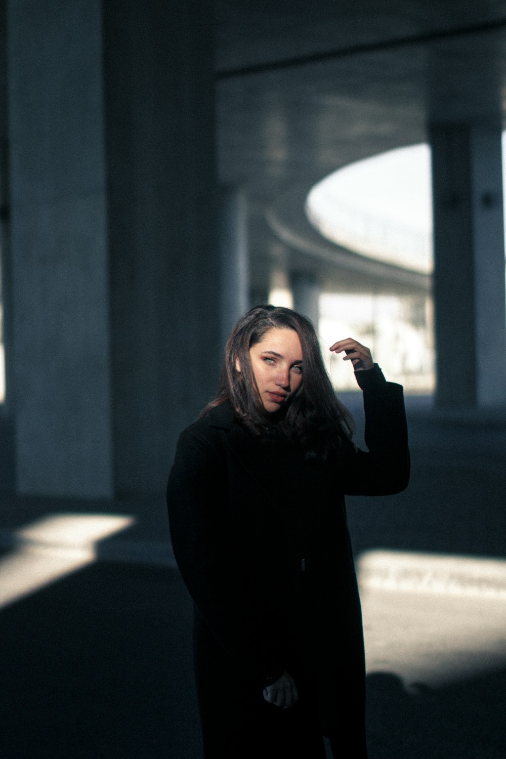 woman in black long sleeve shirt standing on road during daytime