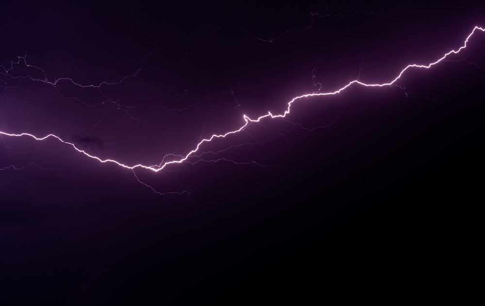 a lightning strike is shown in the dark sky