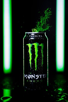 A close-up of a citrus-flavored monster energy drink can.