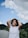 woman in white crew neck t-shirt wearing black sunglasses