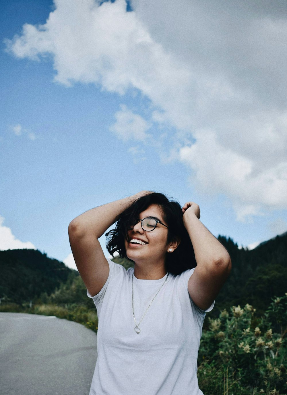 woman in white crew neck t-shirt wearing black sunglasses