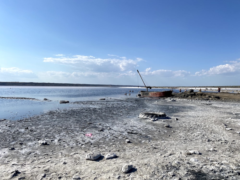 brown wooden boat on sea shore during daytime