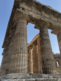 Transparent Greek columns as the main background symbolizing strength and justice.