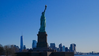A vibrant cityscape of New York City with the Statue of Liberty and skyscrapers under a bright sky.