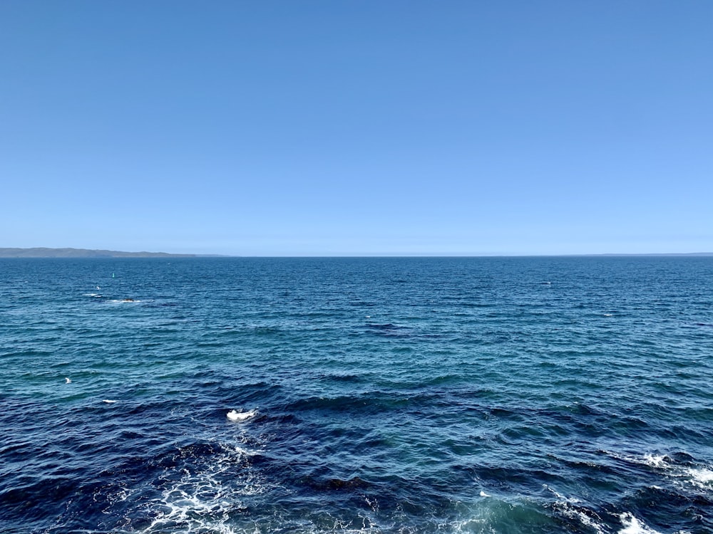 blue ocean water under blue sky during daytime