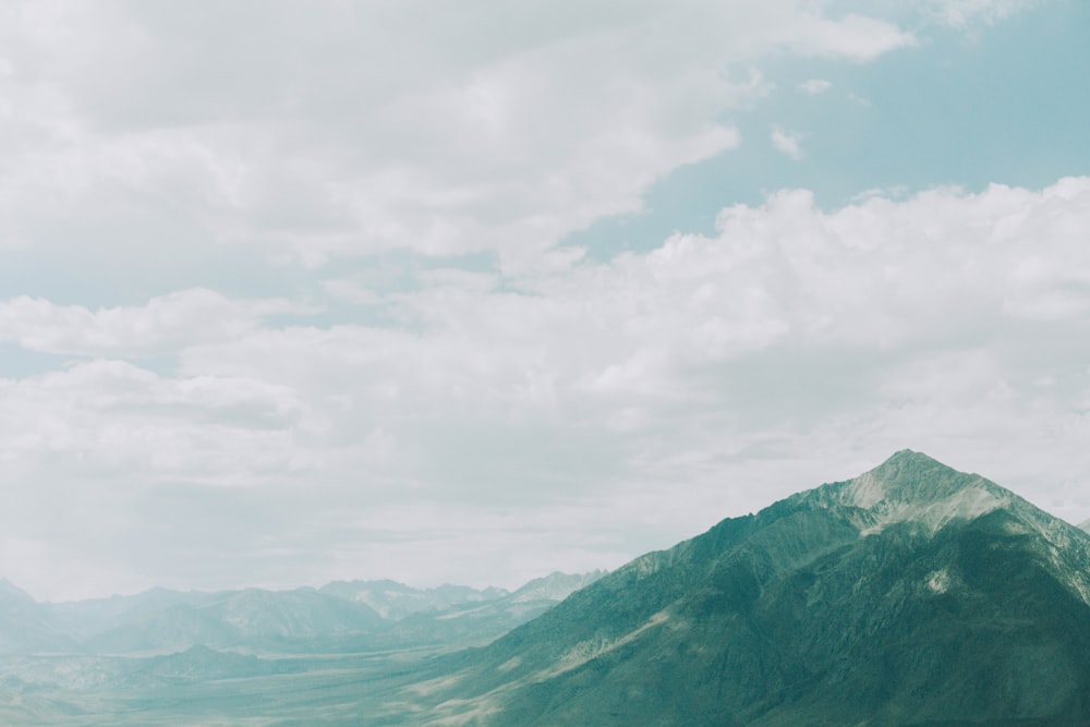 green mountains under white clouds during daytime