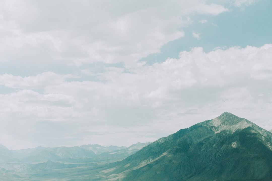 green mountains under white clouds during daytime