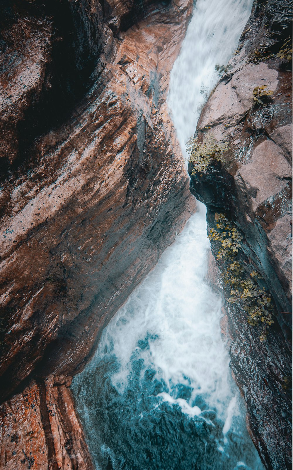 water falls on brown rocky mountain