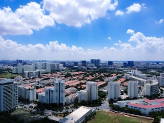 A vibrant cityscape of Delhi NCR showcasing residential and commercial buildings.