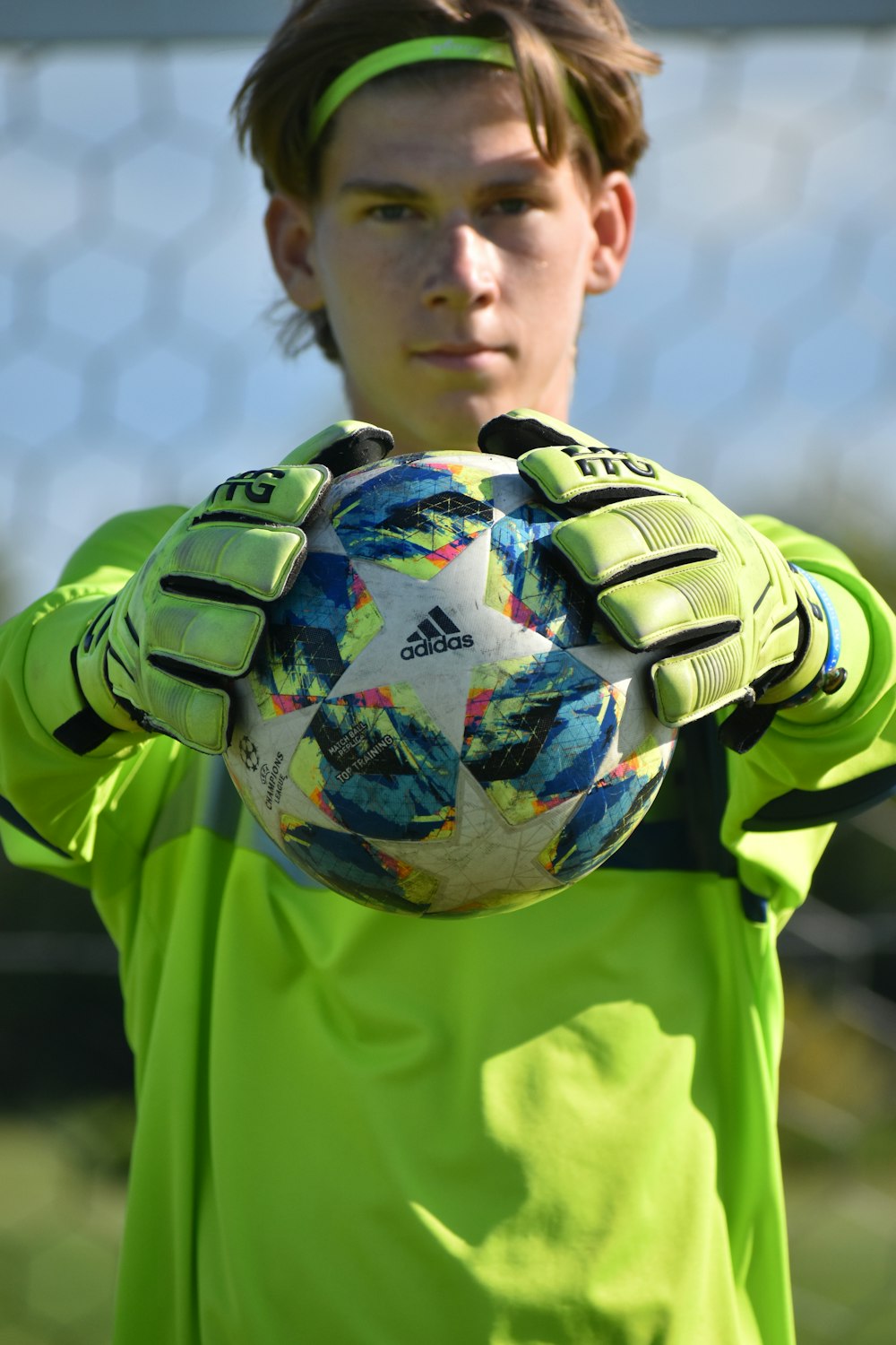 man in green and black adidas soccer jersey