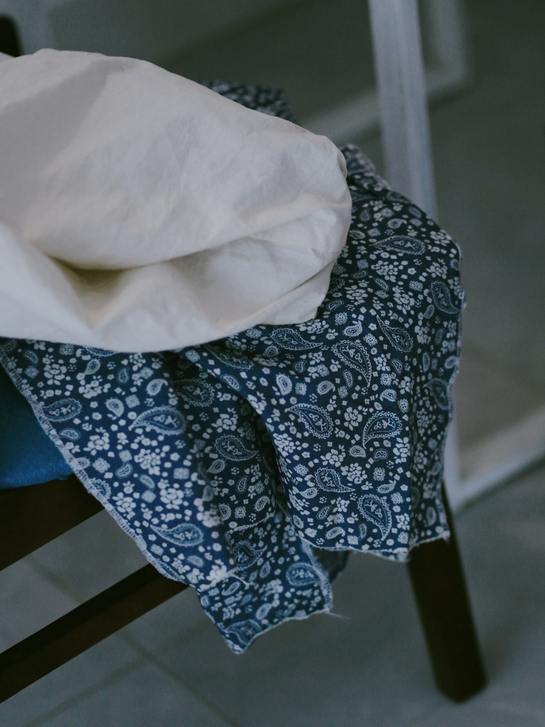 white textile on blue and white floral textile