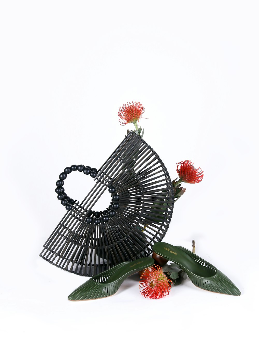 red and white flower on black metal bird cage