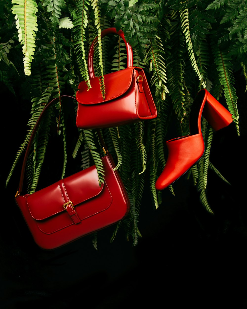 red leather handbag on green pine tree