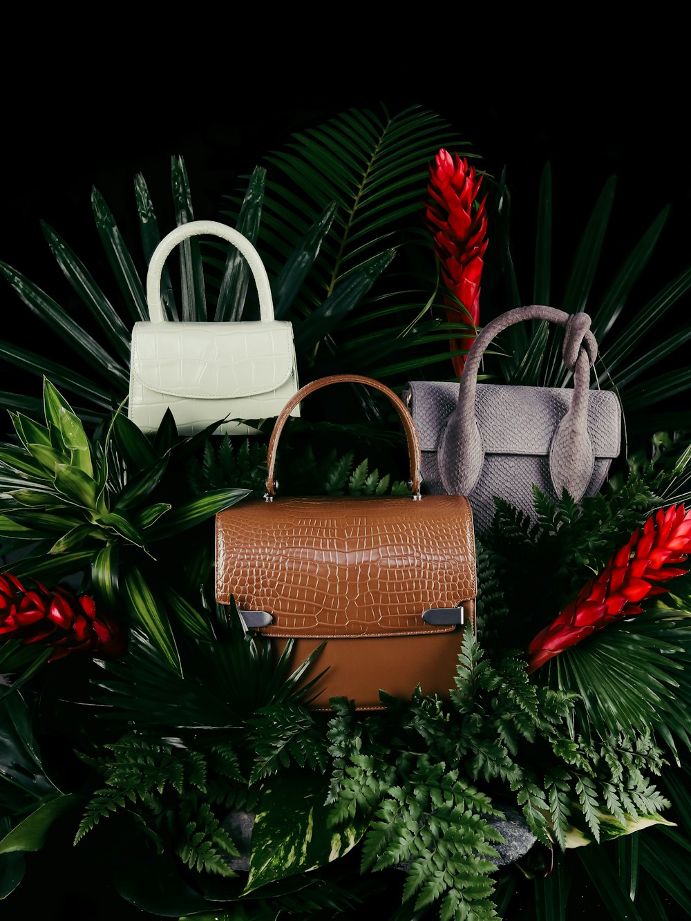 brown leather handbag on green pine tree