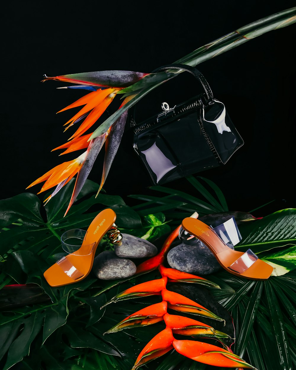 black leather handbag with orange and yellow birds