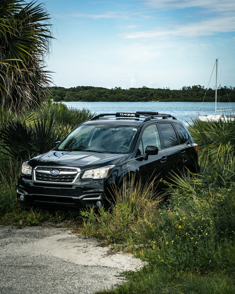 black bmw x 6 parked on beach shore during daytime