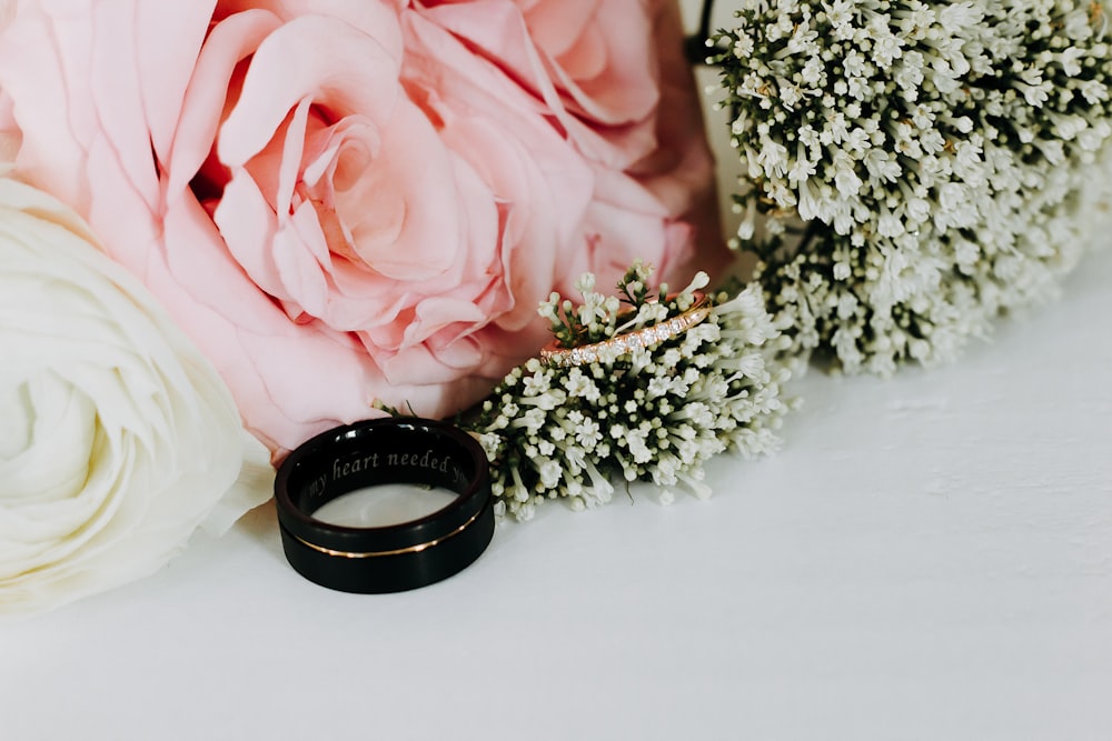 silver and black ring on pink rose