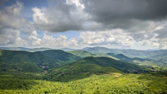 green mountains under white clouds during daytime