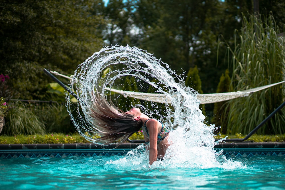 woman in swimming pool during daytime