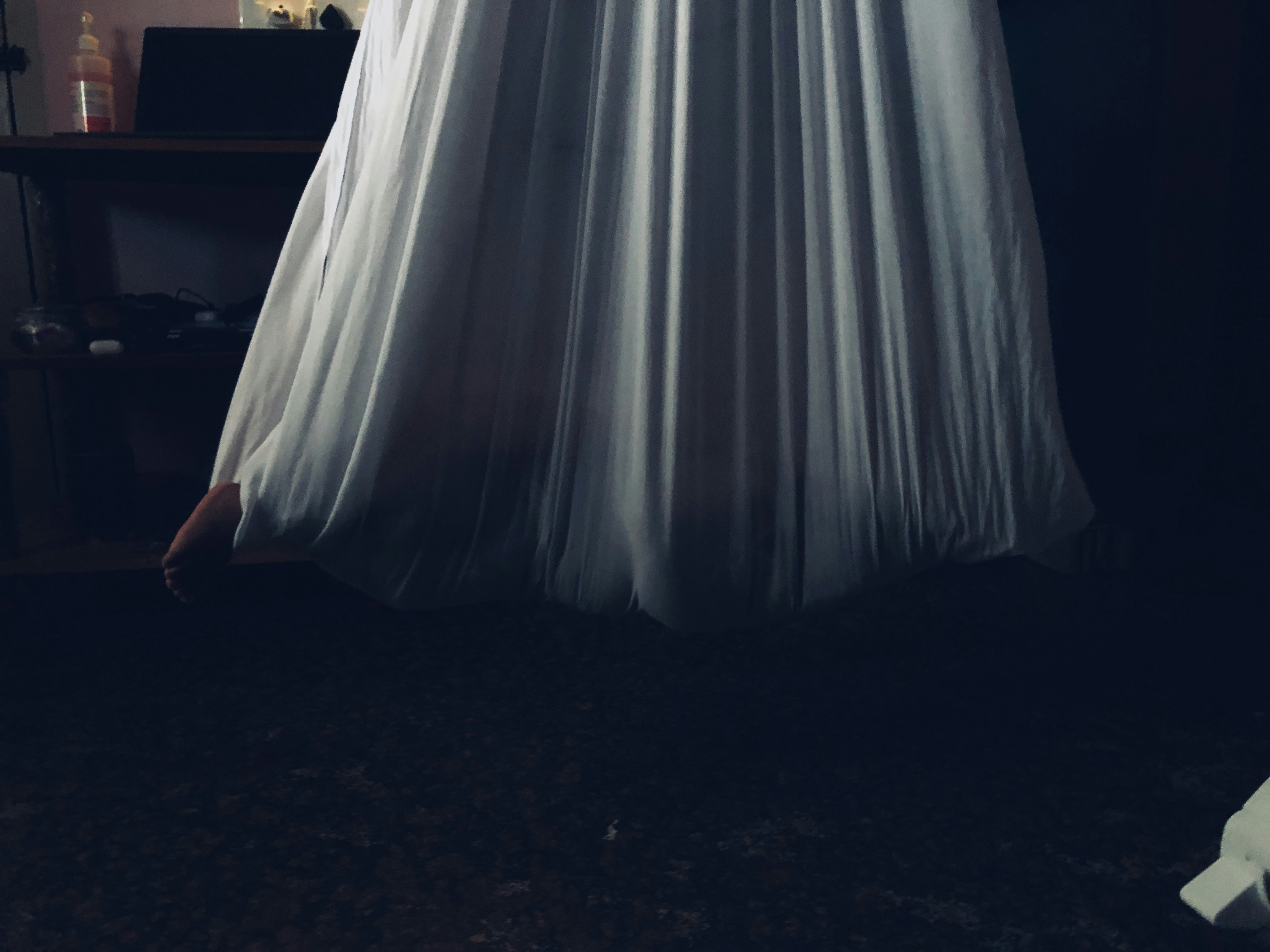 woman in white dress standing on black floor