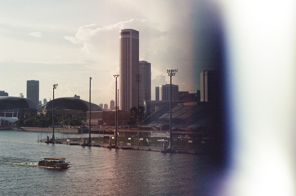 white and black boat on water near city buildings during daytime