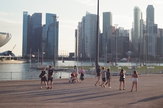 An aerial drone shot capturing a group walk along the waterfront near the Staten Island Ferry Terminal.