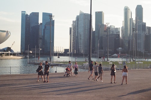 An aerial drone shot capturing a group walk along the waterfront near the Staten Island Ferry Terminal.