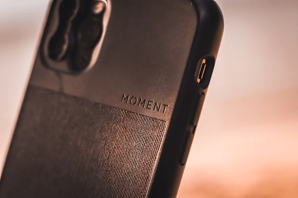 Top view of the iPhone case emphasizing the precise cutouts and material texture.