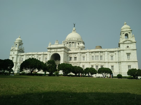 white concrete building under blue sky during daytime in Victoria Memorial India