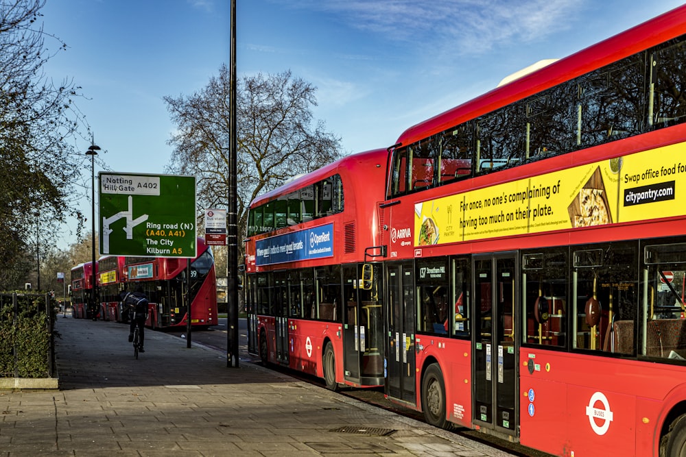 red double decker bus on road during daytime