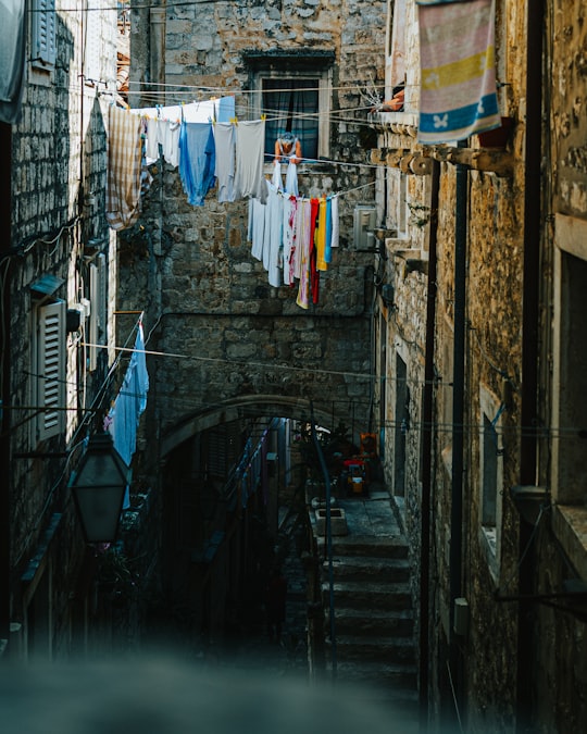 clothes hanged on clothes line on street during daytime in Dubrovnik Croatia