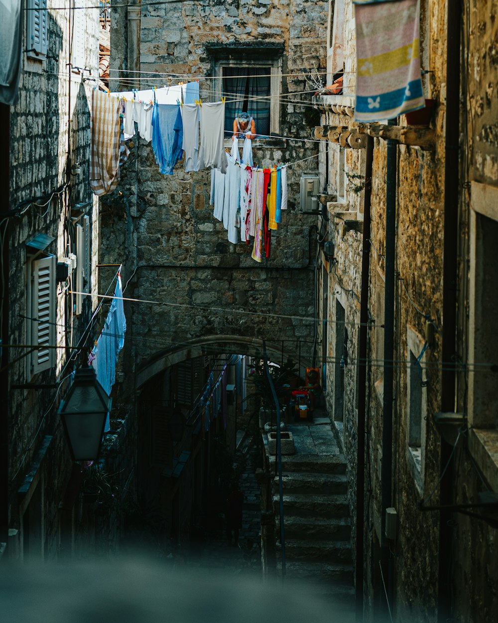 clothes hanged on clothes line on street during daytime