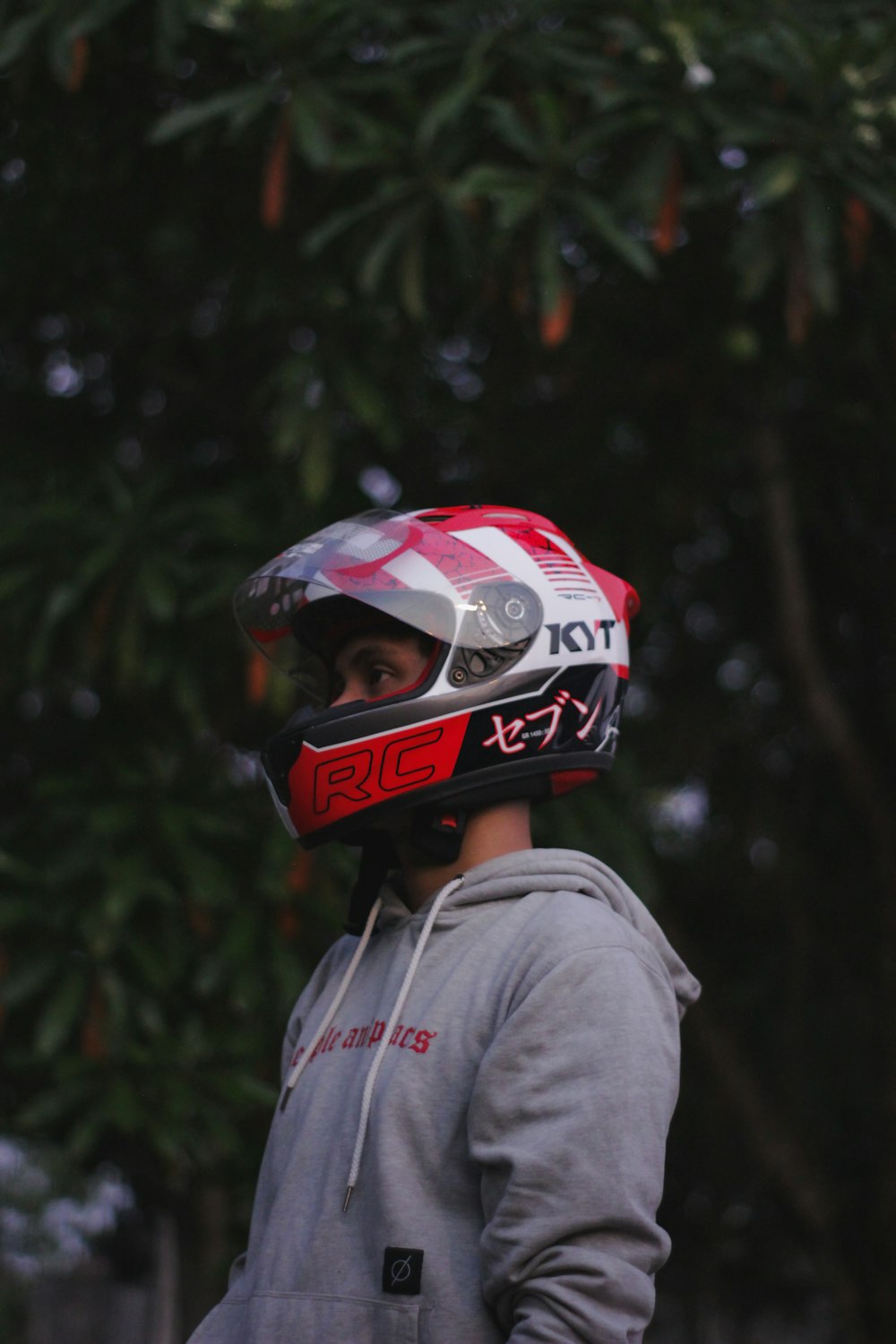person in gray hoodie wearing red white and black helmet