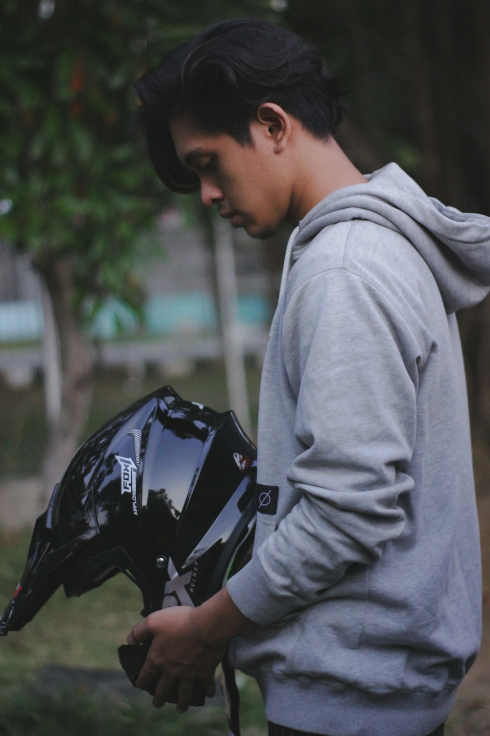 man in gray hoodie carrying black backpack