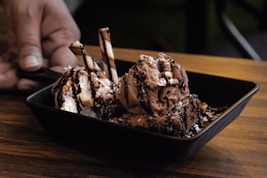 chocolate ice cream on black ceramic bowl