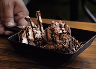chocolate ice cream on black ceramic bowl