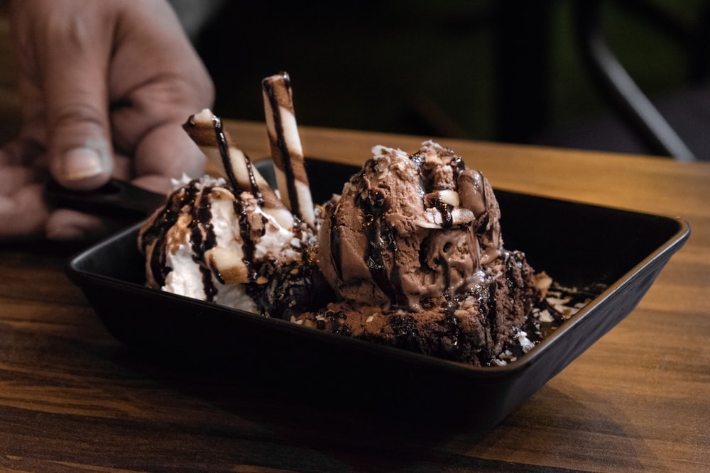 chocolate ice cream on black ceramic bowl