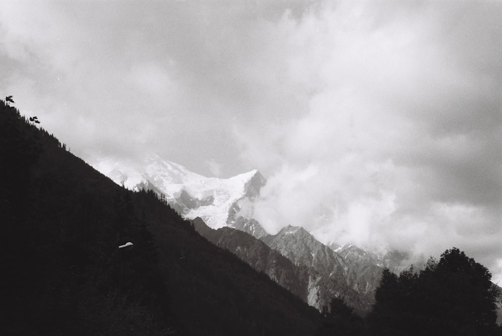 snow covered mountain under cloudy sky during daytime