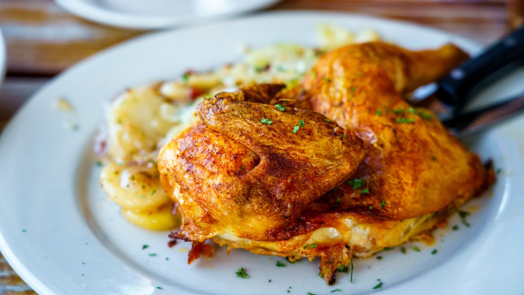 cooked food on white ceramic plate, Grillhendl (Oktoberfest Style Roasted Half Chicken) in the Hofbräuhaus Pittsburgh.