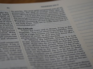A close-up of a page from a book, specifically focusing on a section titled 'The Sabbath'. The text is printed in a serif font and includes a passage discussing religious observance. The right side of the page shows lined sections for note-taking.