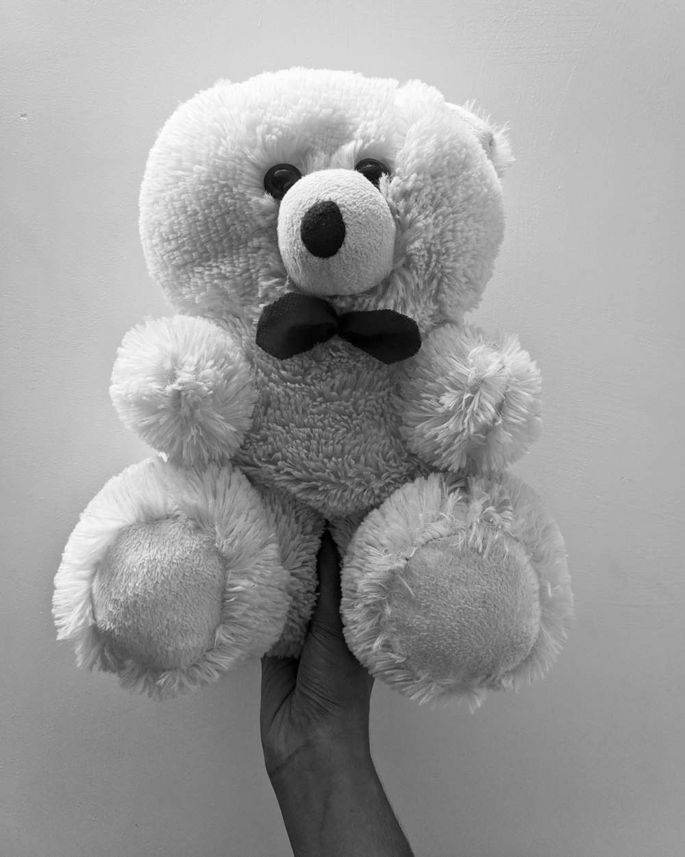 white teddy bear on white textile